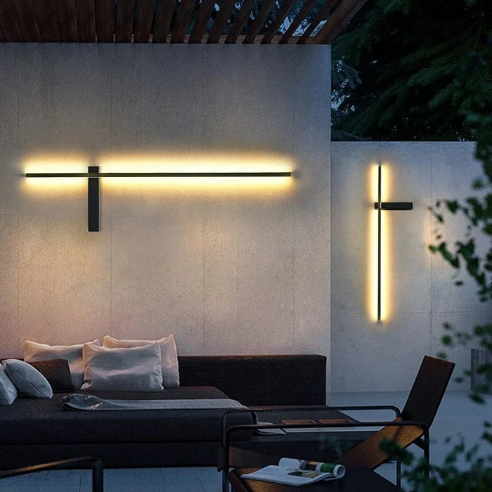 The Axis Outdoor Light horizontal and vertical LED wall lights on a patio wall