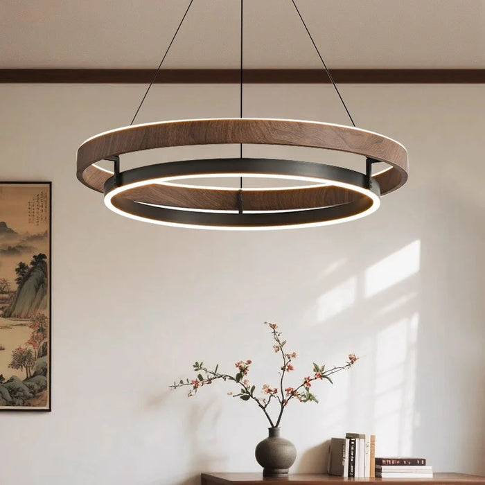 The Savore Pendant Light wood-effect double ring LED pendant in a living room