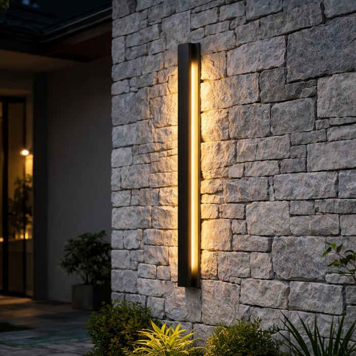Obsidian Outdoor Wall Light tall black LED bar on a natural stone wall