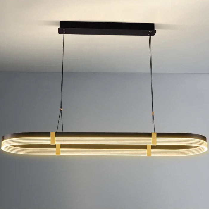 Modern pendant light with black and gold design on a neutral background