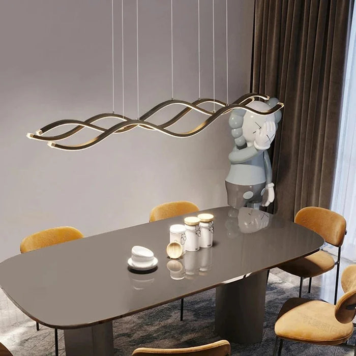 Luminara Three Wave LED Pendant Light in gold over a dining table