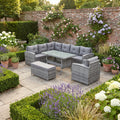 Devon Corner Dining Sofa Set in grey rattan – L-shaped corner sofa, armchair, bench and glass-top dining table on a garden patio