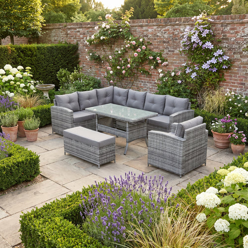 Devon Corner Dining Sofa Set in grey rattan – L-shaped corner sofa, armchair, bench and glass-top dining table on a garden patio