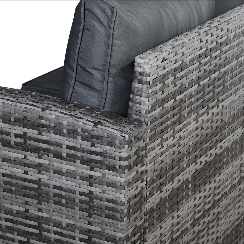 Close-up of the Devon Corner Dining Sofa Set showing the woven grey PE rattan armrest and deep-filled cushion detail
