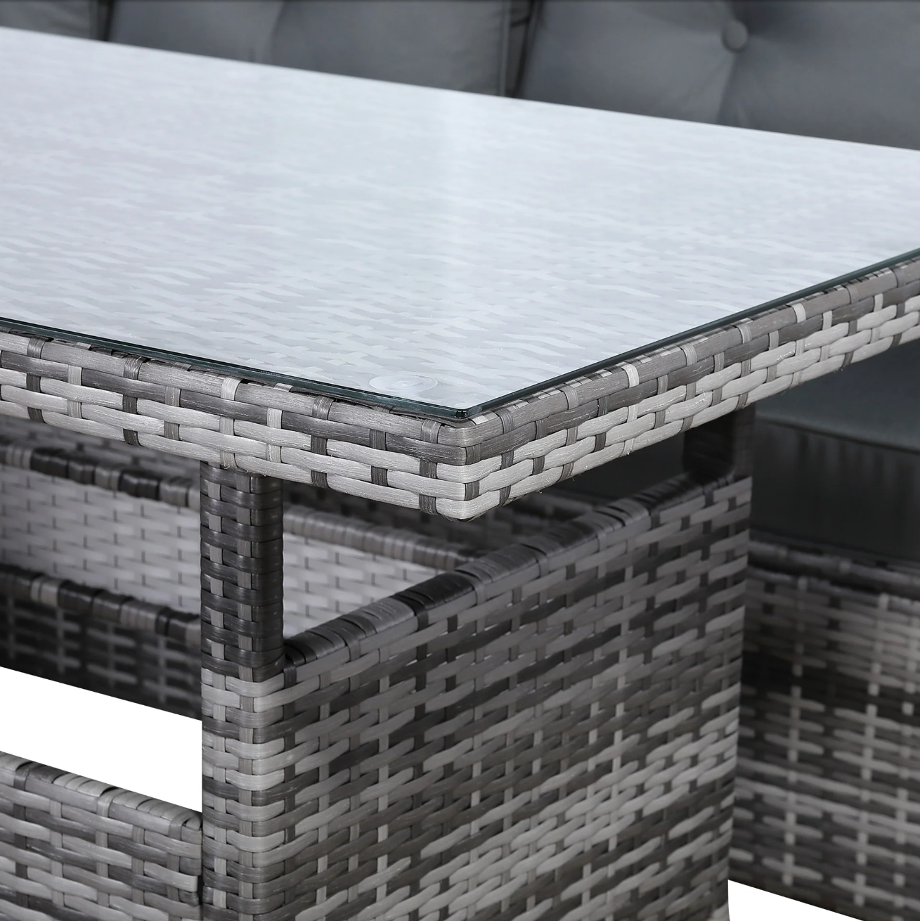 Devon Corner Dining Sofa Set – close-up of the tempered glass-top dining table with woven grey rattan base