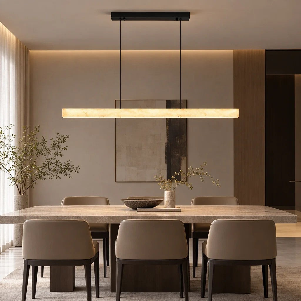 Alabastro linear onyx pendant light glowing warm white above a modern dining table