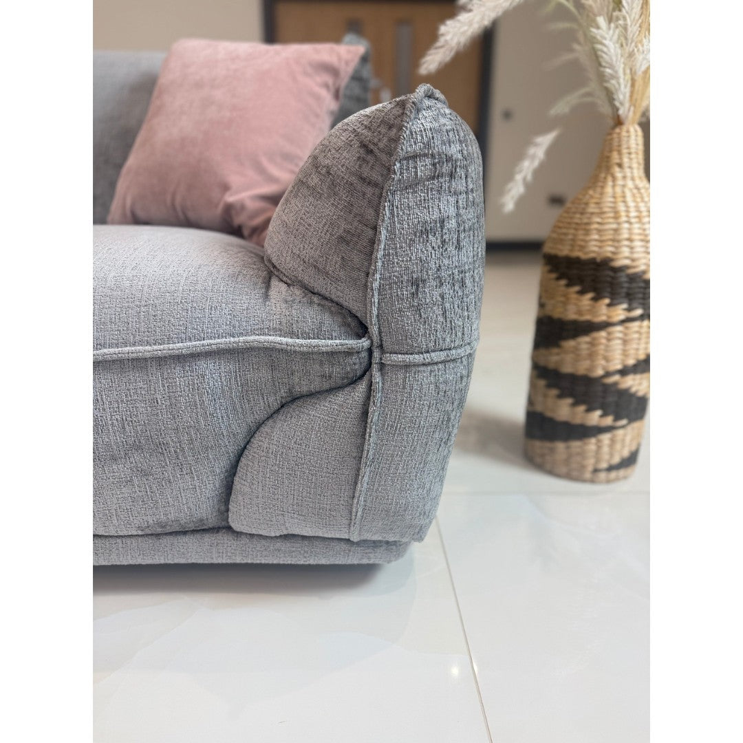 Close-up of the cushioned armrest and piped detailing on the grey Bergamo 3 seater sofa