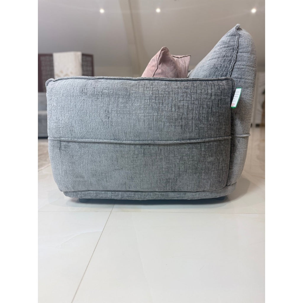 Side profile of the grey Bergamo sofa showing the rounded arm and textured fabric