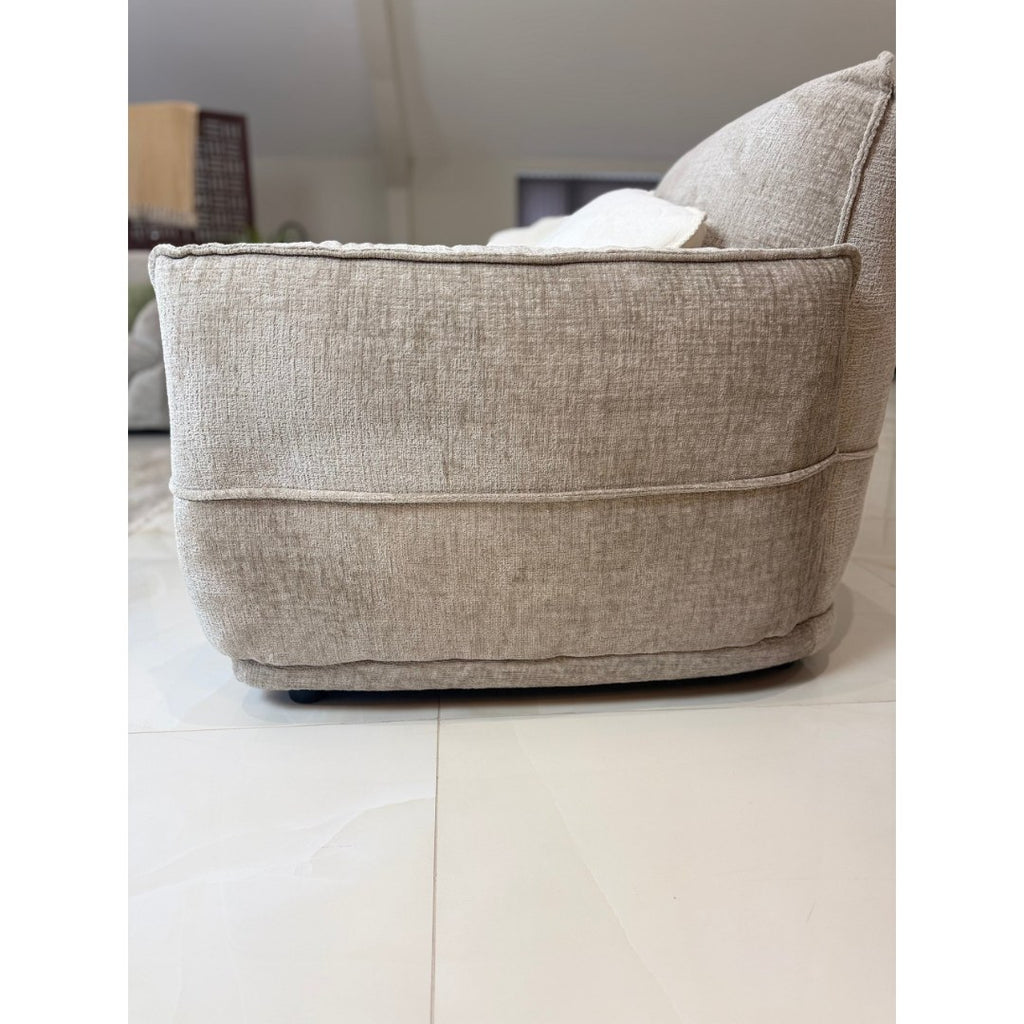 Side view of the beige Bergamo sofa showing the high back and 99 cm depth