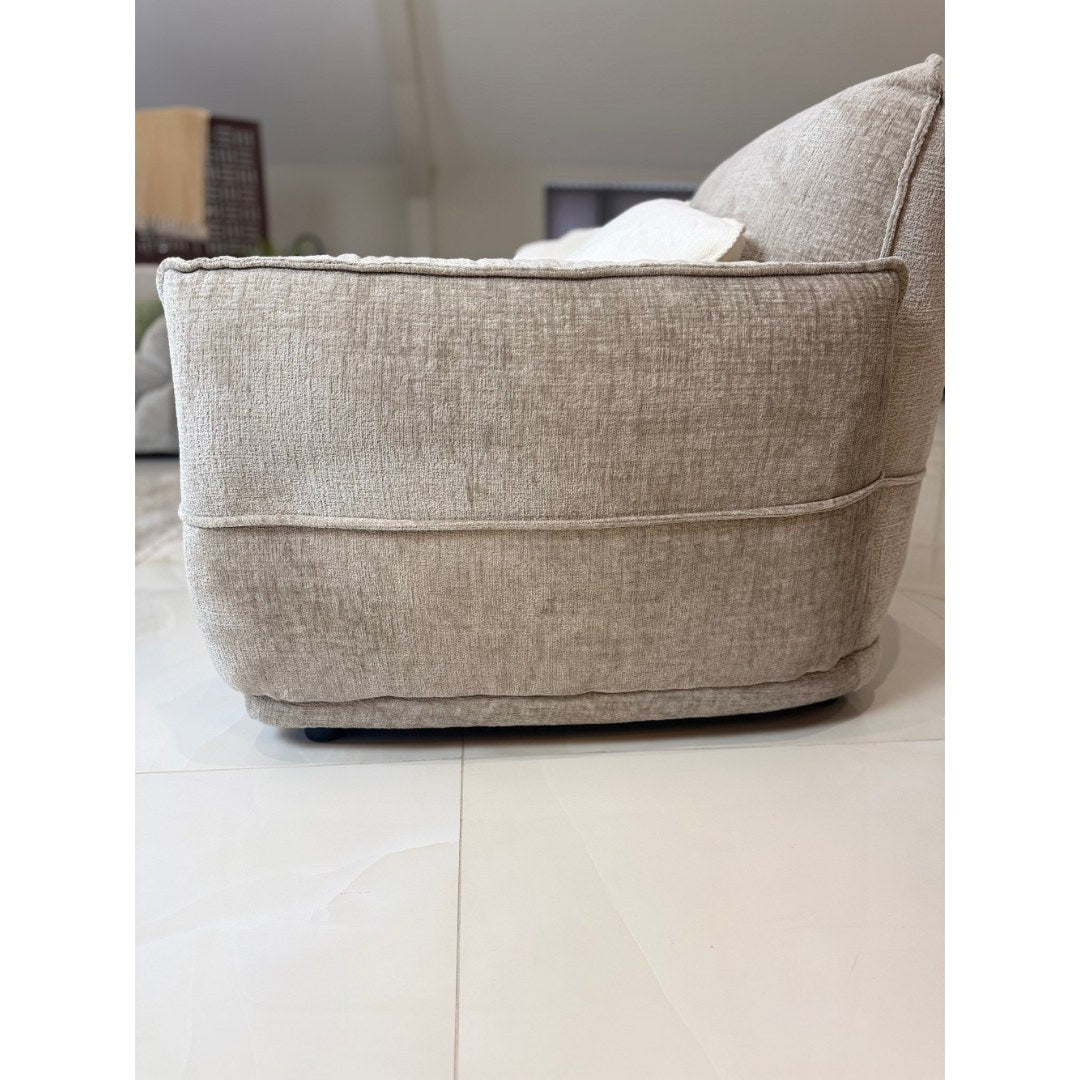 Side view of the beige Bergamo sofa showing the high back and 99 cm depth
