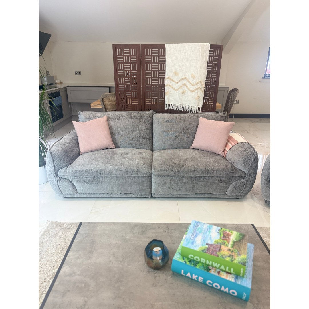 Grey Bergamo 3 seater fabric sofa with plump back cushions and piped detailing