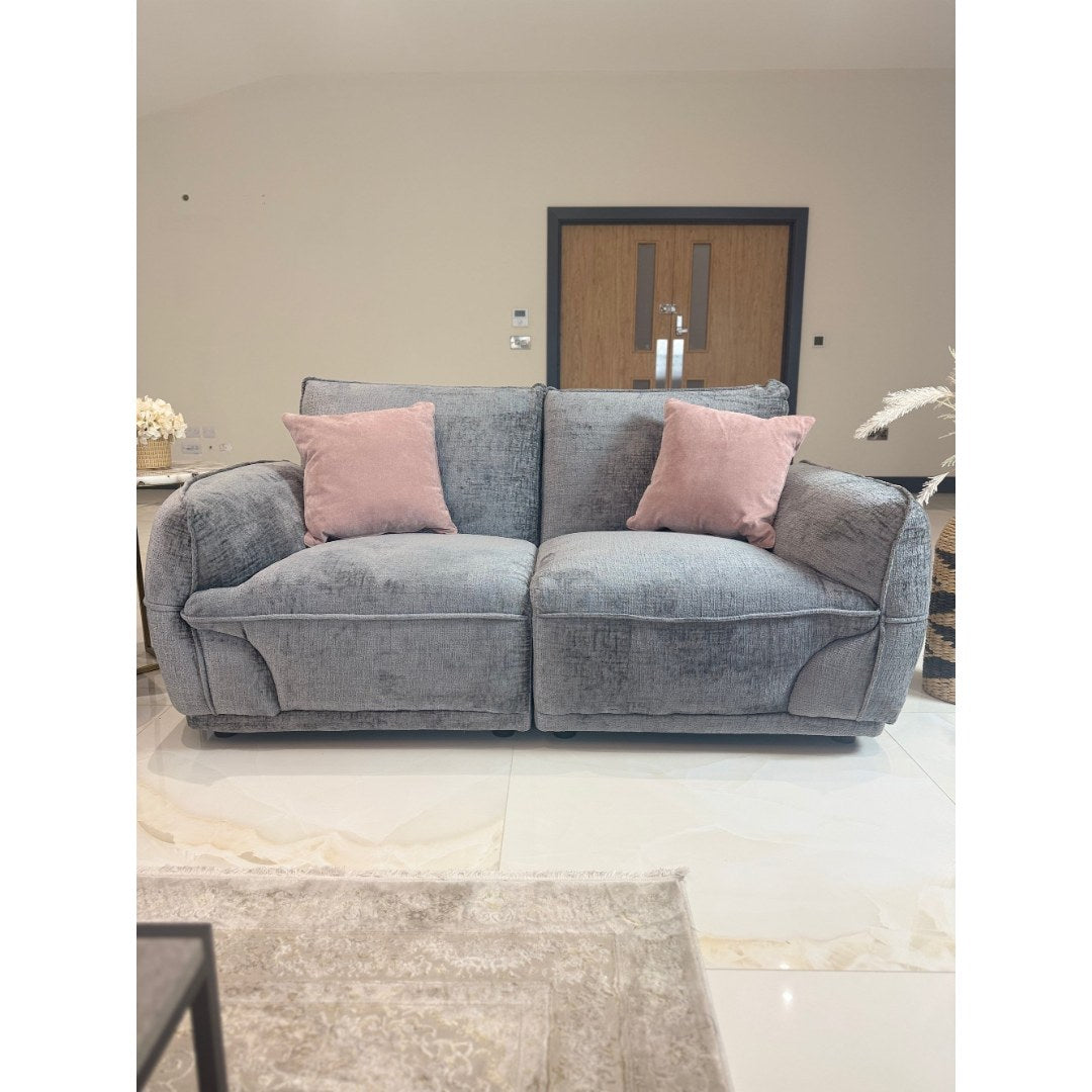 Angled view of the grey Bergamo 2 seater sofa with padded scroll arms