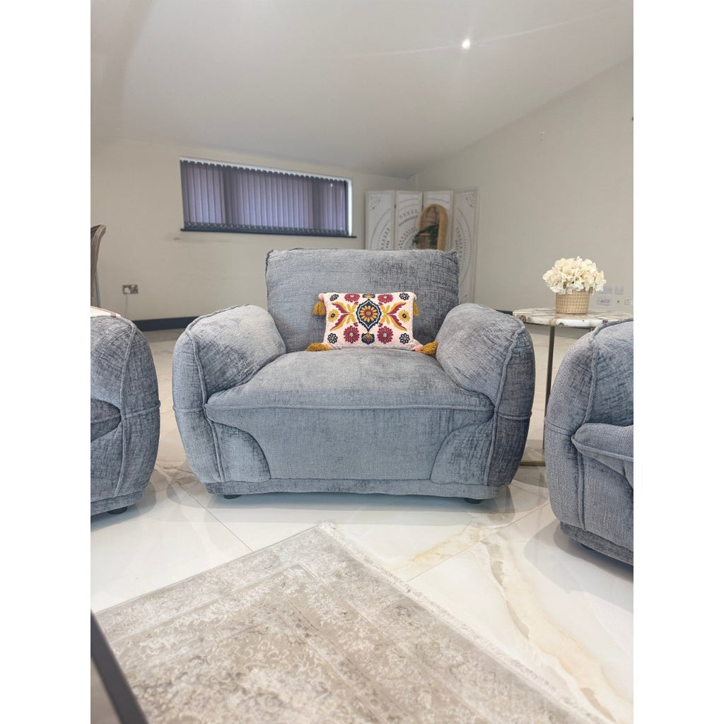 Angled view of the grey Bergamo armchair with deep seat and padded arms