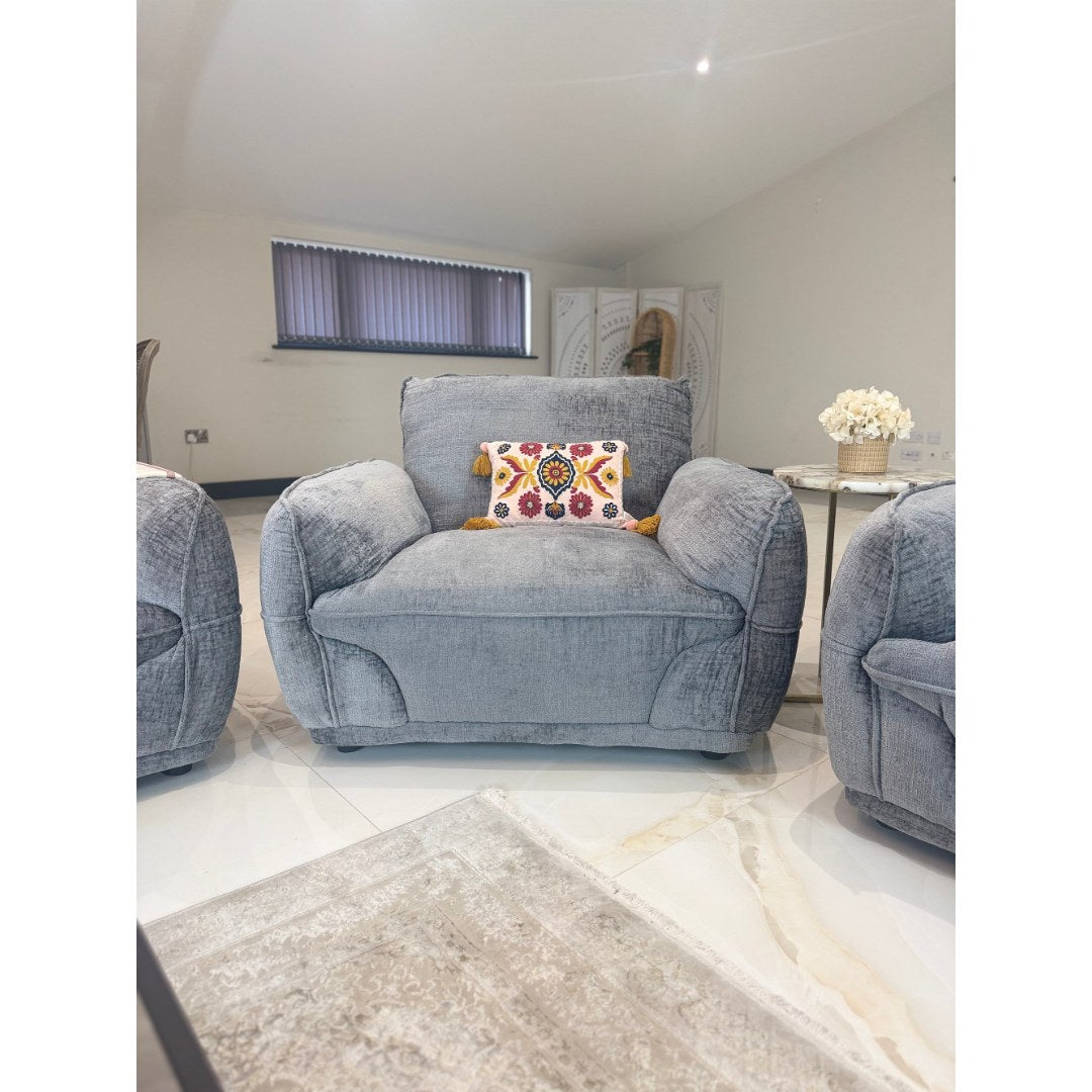 Angled view of the grey Bergamo armchair with deep seat and padded arms