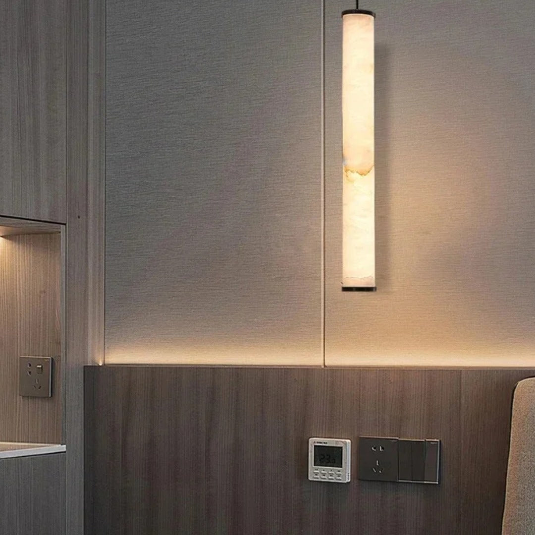 Calacatta marble pendant light used as a bedside light in a contemporary bedroom with wood panelling