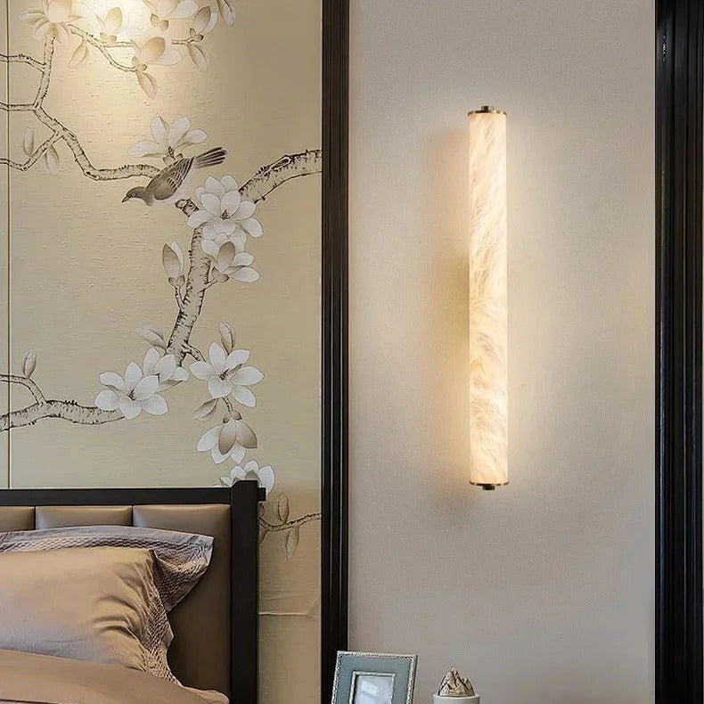 Calacatta gold marble wall light used as bedside lighting beside a headboard