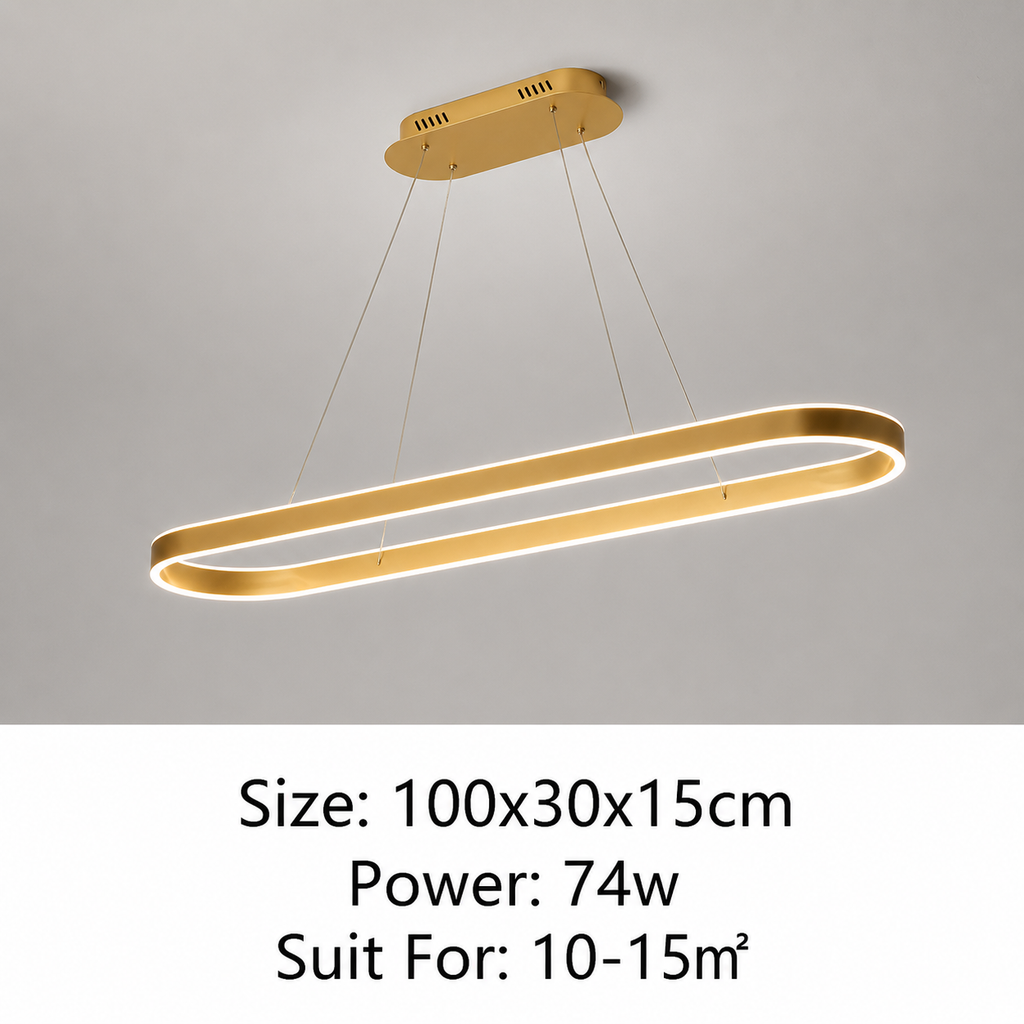 A modern linear LED pendant light in a brushed gold finish, suspended from a matching gold ceiling mount against a light gray wall. Text at the bottom specifies the size (100x30x15cm), power (74w), and suitability for a 10-15m² room.