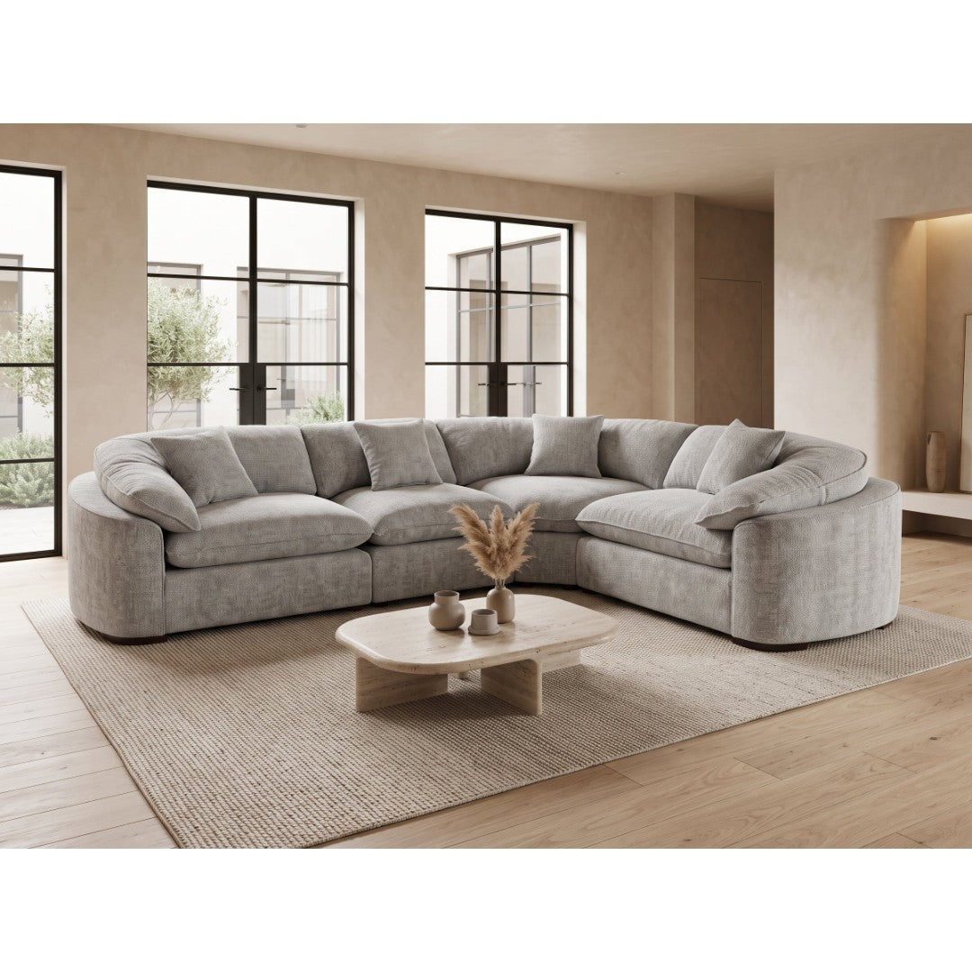 Helena large curved corner sofa in grey fabric with deep pillow-top seats in a bright modern living room