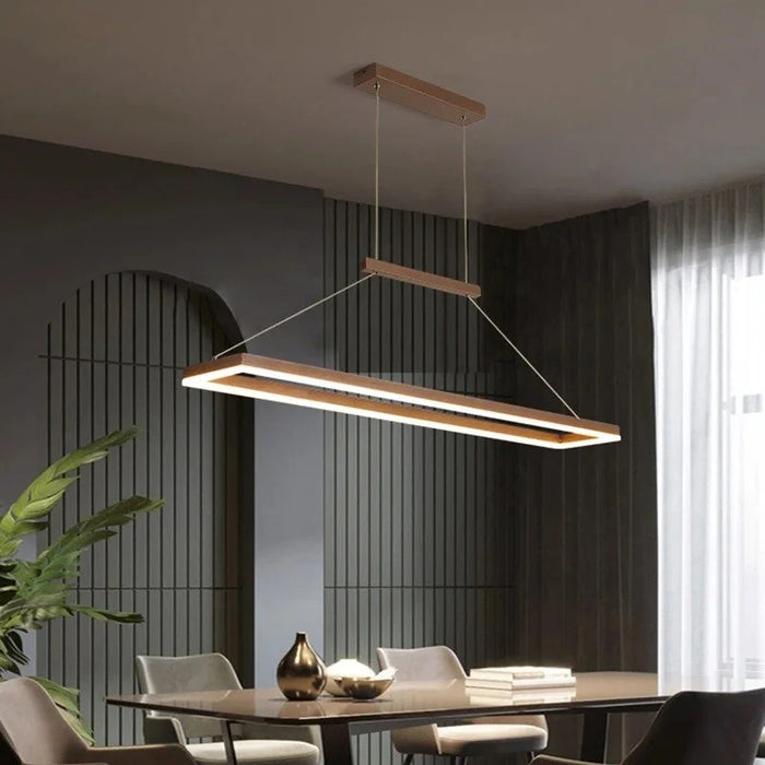 The ModaRect rectangular LED pendant light in wood finish over a dining table