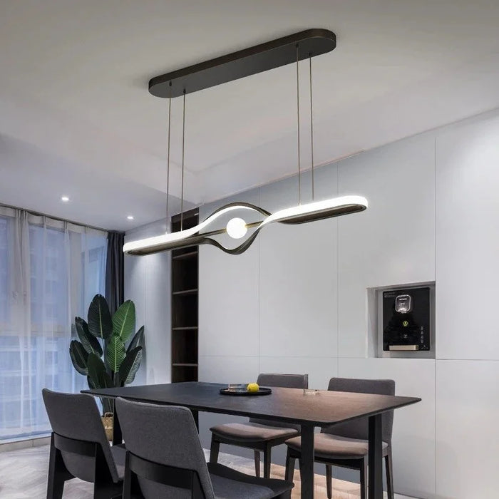 The Orb linear LED pendant with central glass orb above a dining table