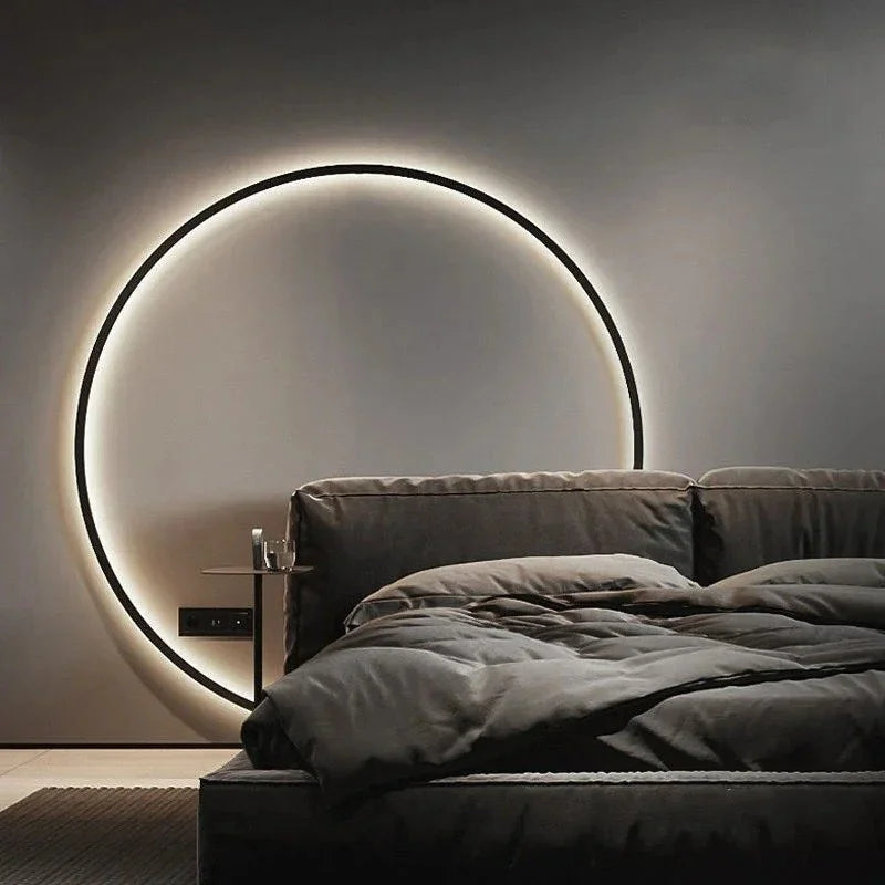 Luminous Halo V1 large circular LED ring wall light used as a dramatic bedroom headboard feature – luxury circular LED wall light UK by Luxe Bespoke