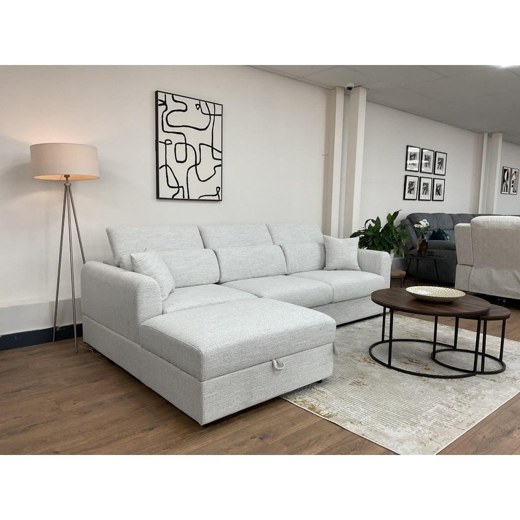 Beige Milano corner sofa with the chaise beside a round coffee table