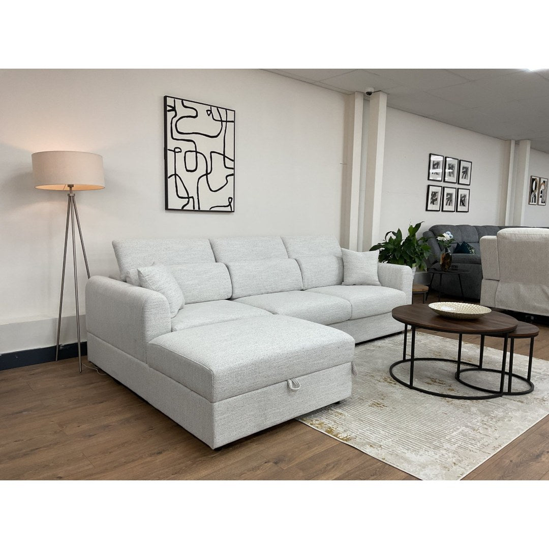 Beige Milano corner sofa with the chaise beside a round coffee table