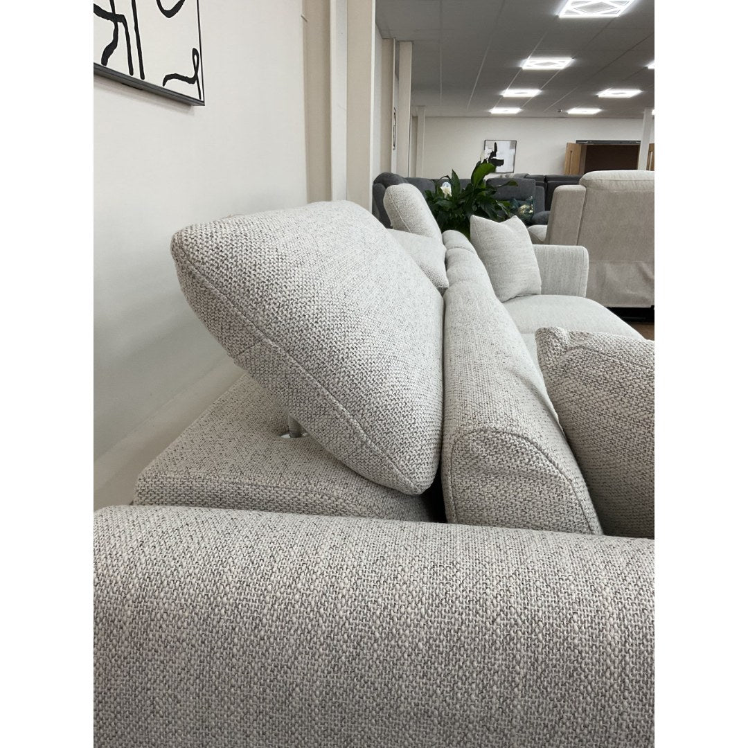 Adjustable headrest on the beige Milano sofa shown raised