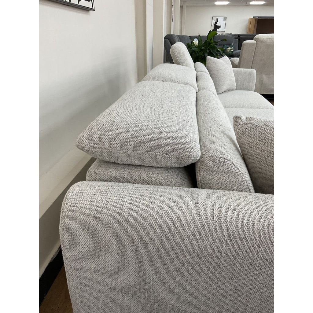 Side view of the beige Milano sofa with headrests raised