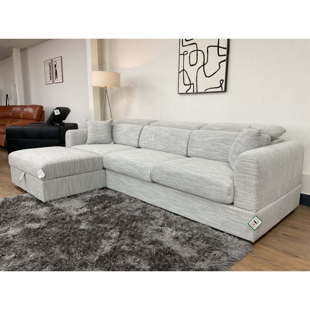 Grey Milano corner sofa with the chaise on the left, styled on a grey shaggy rug
