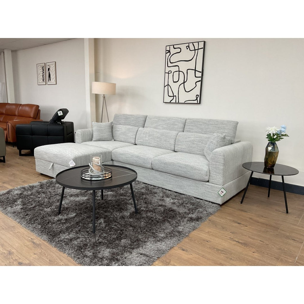Grey Milano L-shape sofa with a round coffee table in a bright living room