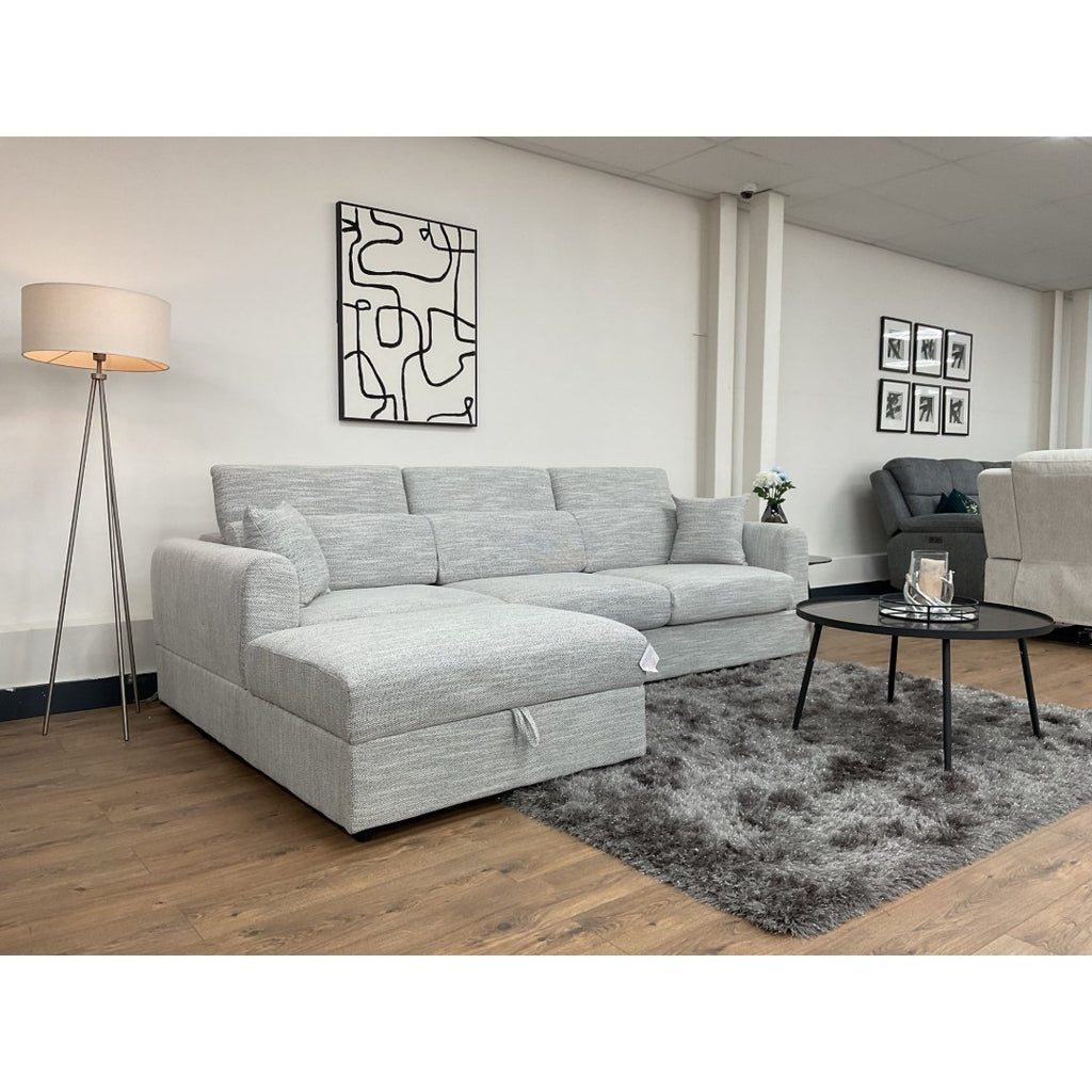 Side angle of the grey Milano corner sofa with chaise and coffee table