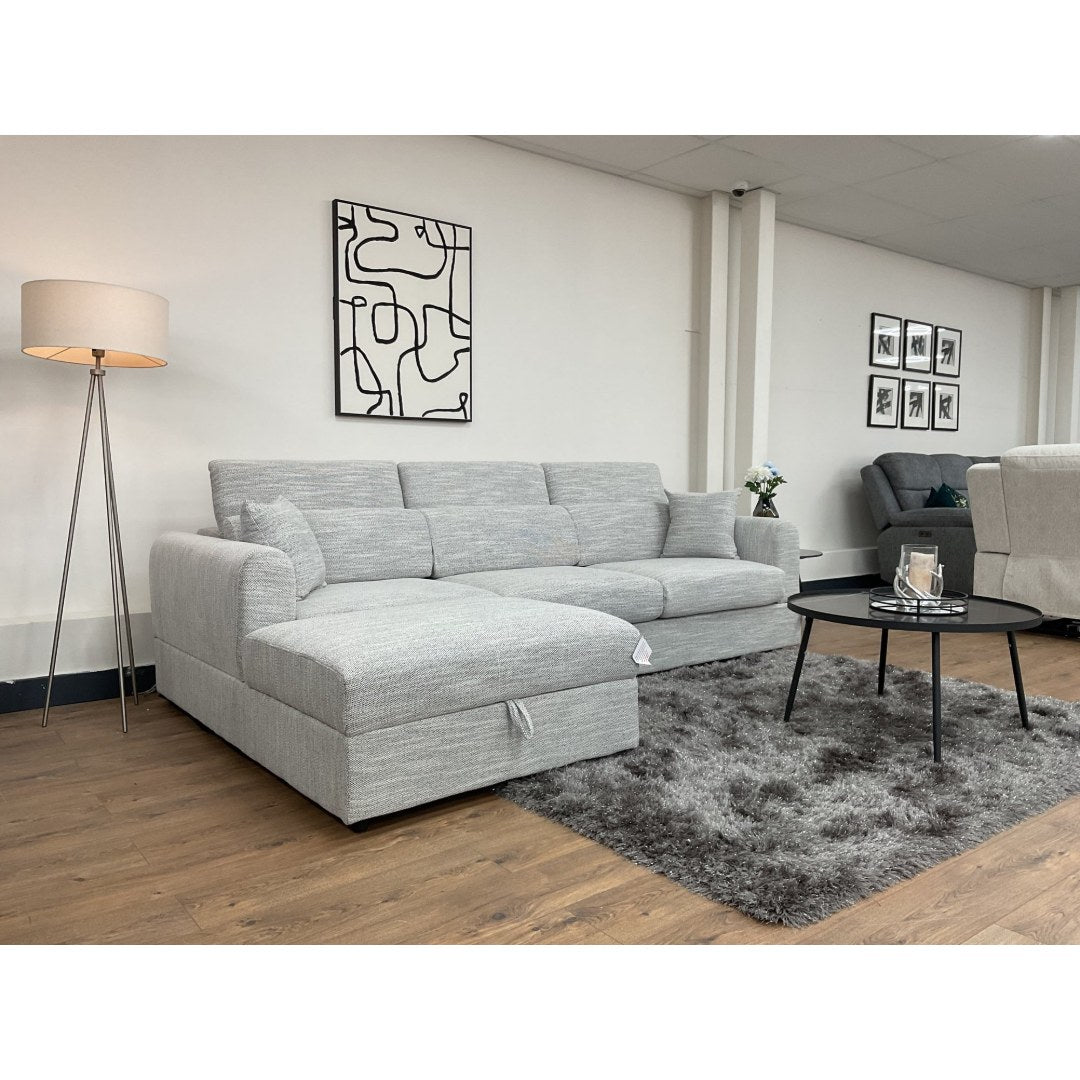 Side angle of the grey Milano corner sofa with chaise and coffee table