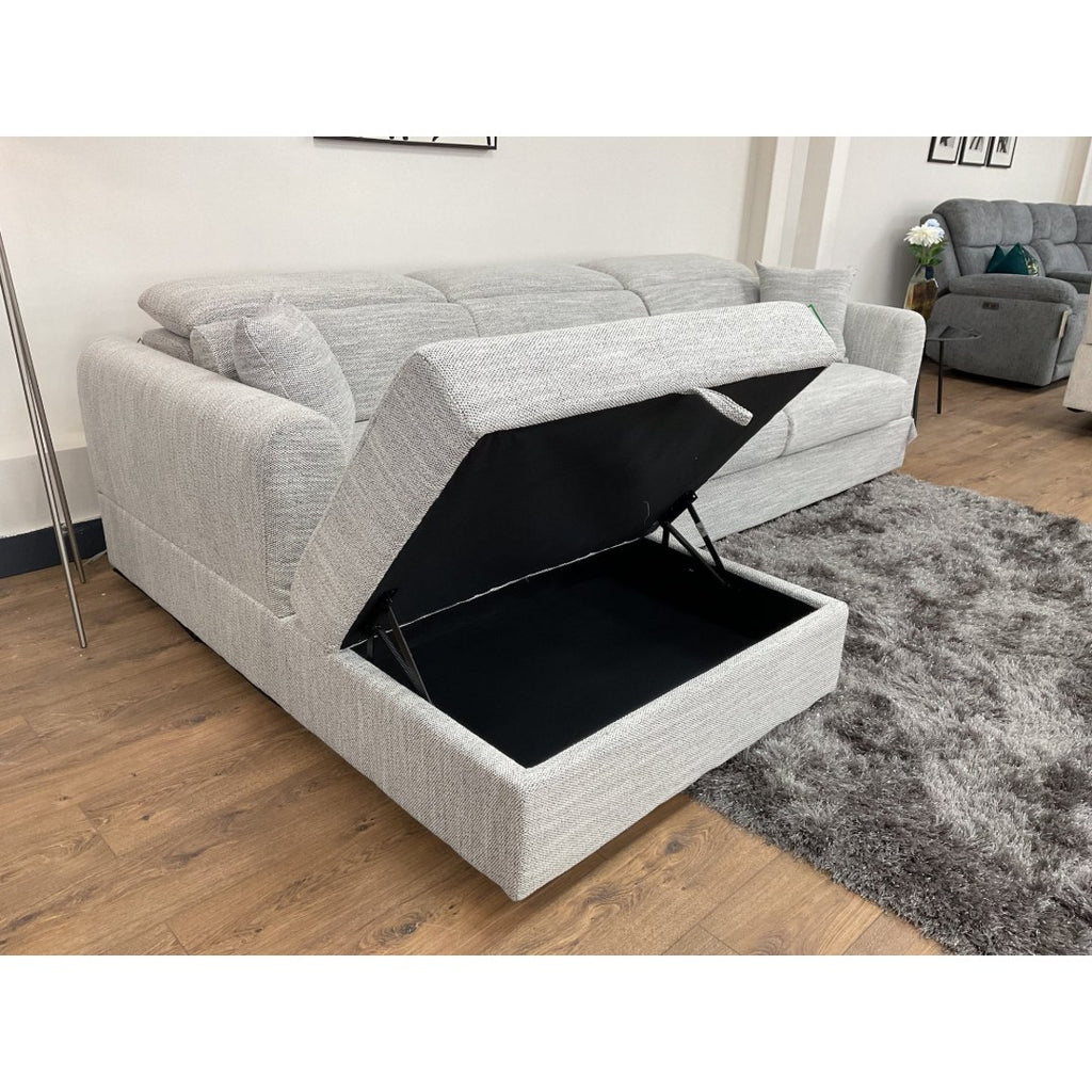 Grey Milano corner sofa with the chaise lifted to reveal the hidden storage compartment