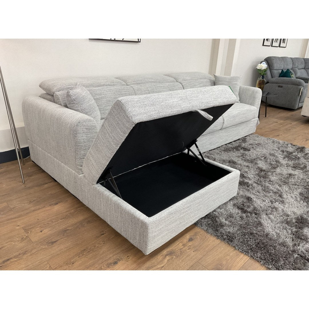 Grey Milano corner sofa with the chaise lifted to reveal the hidden storage compartment
