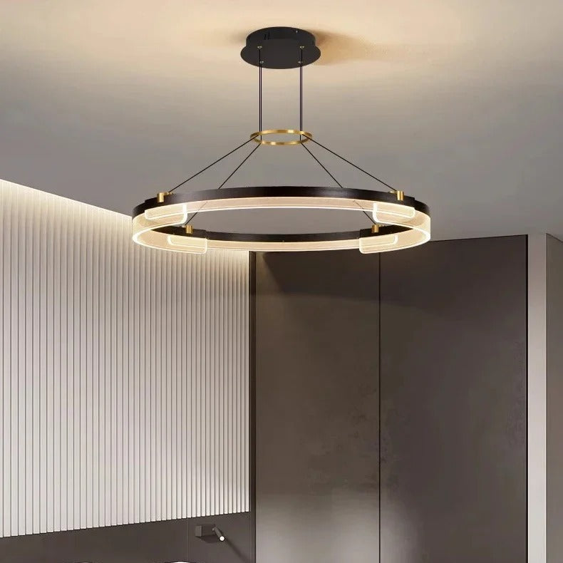 Radiant V1 LED ring chandelier beside a fluted wall panel