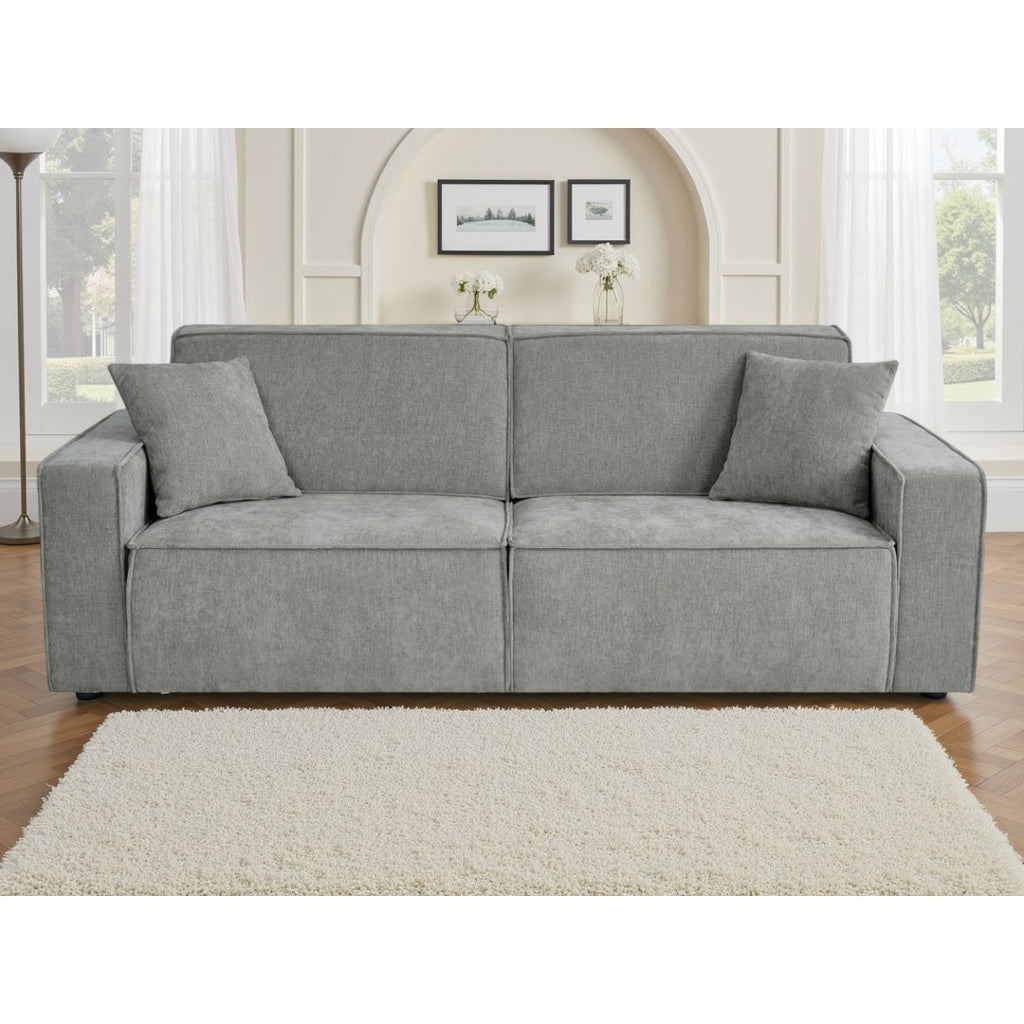 Front view of the grey Siena electric sofa bed with two matching cushions in a bright living room