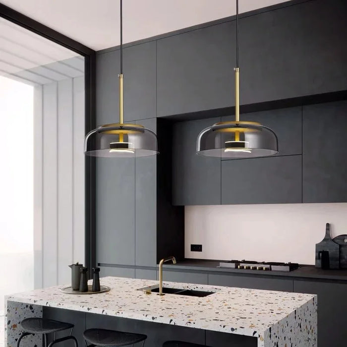 The Halo Sphere glass and brass pendant lights over a terrazzo kitchen island